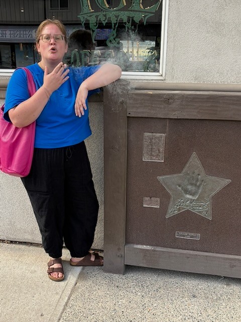 Lyle Lovett handprint plaque — Mara tests the legend.